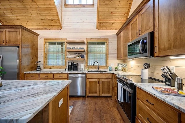 kitchen featuring light stone countertops, a healthy amount of sunlight, and stainless steel appliances