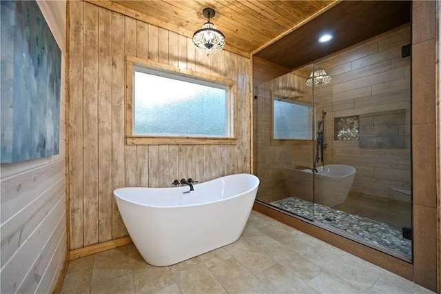 bathroom with an inviting chandelier, separate shower and tub, wooden walls, and wood ceiling