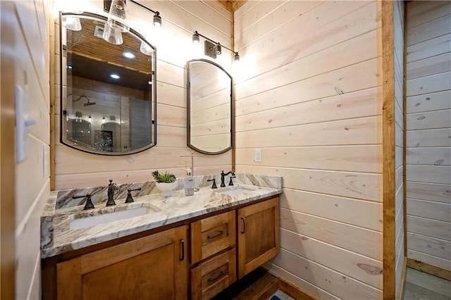 bathroom with vanity and wood walls