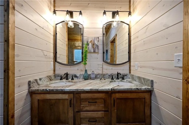 bathroom featuring wood walls and vanity