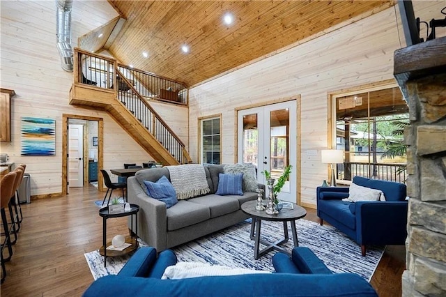 living room with hardwood / wood-style flooring, wooden walls, french doors, high vaulted ceiling, and wood ceiling