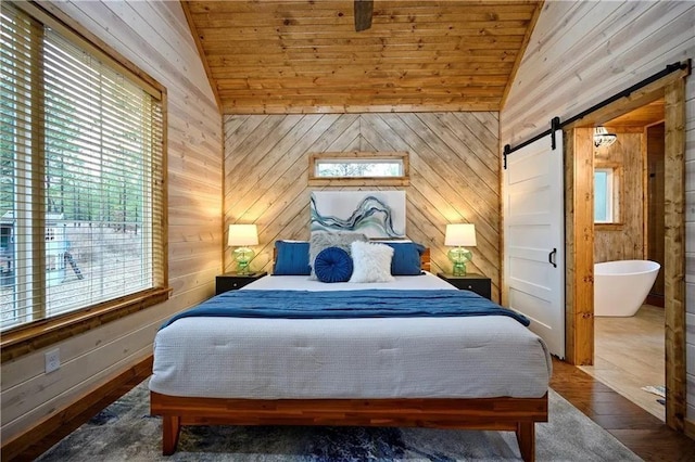 bedroom with wooden ceiling, lofted ceiling, wooden walls, and a barn door