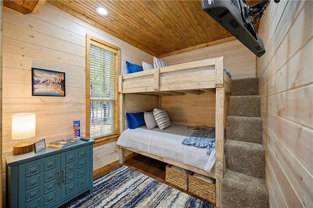 bedroom featuring wooden ceiling and wood walls