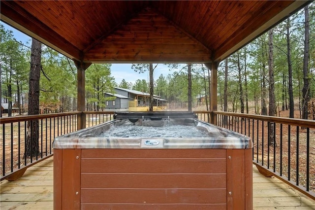 wooden deck with a gazebo and a hot tub