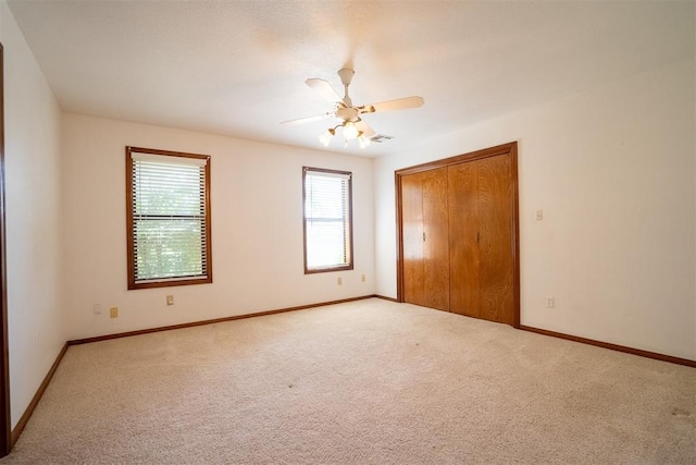 carpeted empty room with ceiling fan