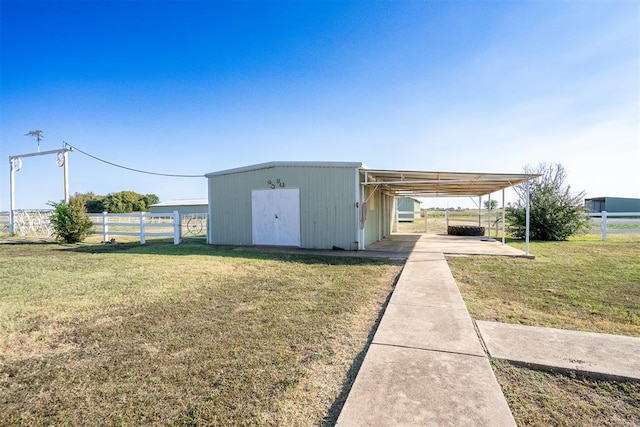 view of outbuilding featuring a lawn