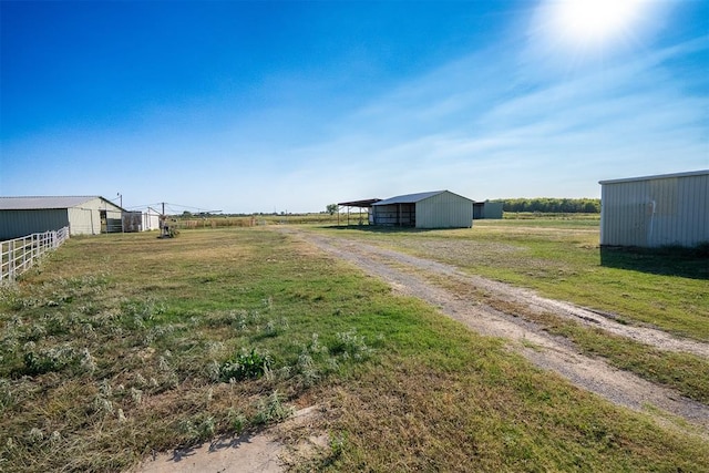 view of yard featuring an outbuilding and a rural view