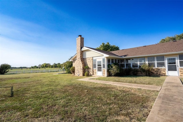 view of side of property with a lawn