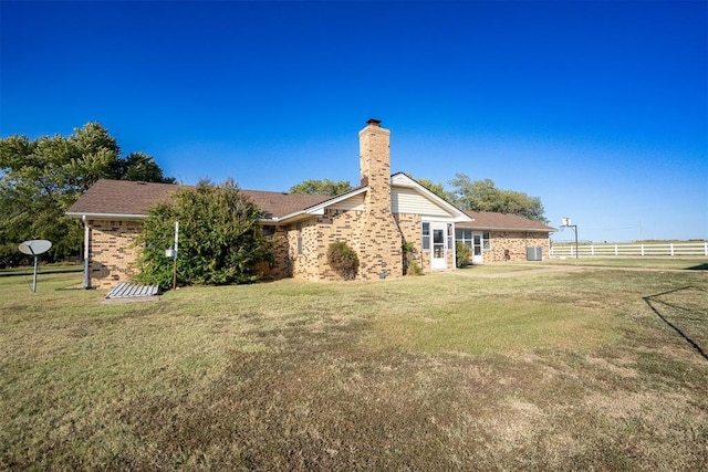 rear view of property featuring a yard