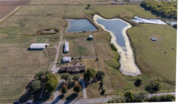 drone / aerial view featuring a water view and a rural view