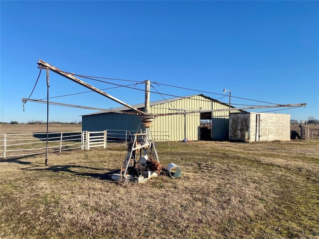 view of yard featuring an outbuilding and a rural view