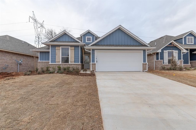 craftsman inspired home featuring concrete driveway, brick siding, board and batten siding, and an attached garage