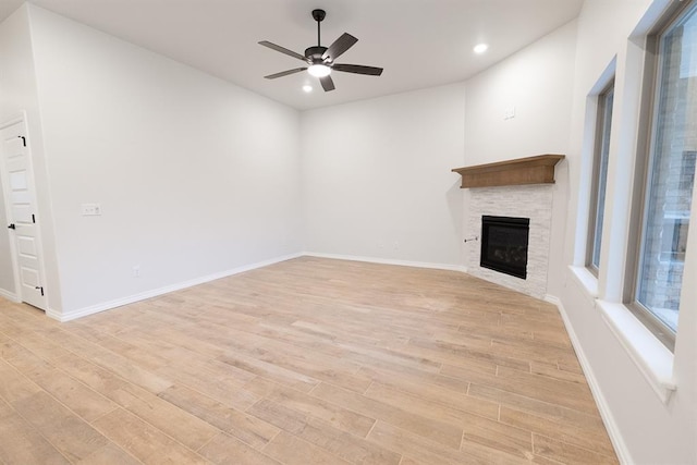 unfurnished living room featuring light wood-style flooring, baseboards, and ceiling fan