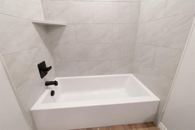 bathroom with a bathtub and wood finished floors