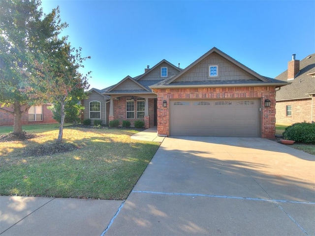 craftsman house featuring a front yard and a garage