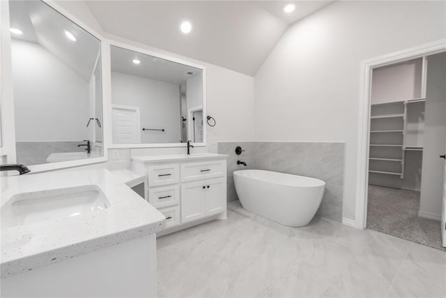14001 Birch Ln, Edmond, OK 73049 - full bathroom featuring double vanity, a freestanding bath, recessed lighting, marble finish flooring, and vaulted ceiling