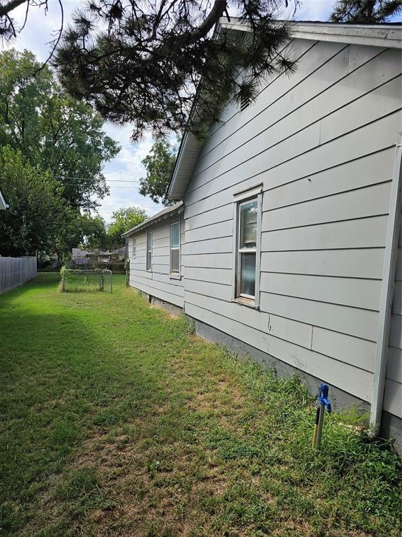 view of side of home with a yard