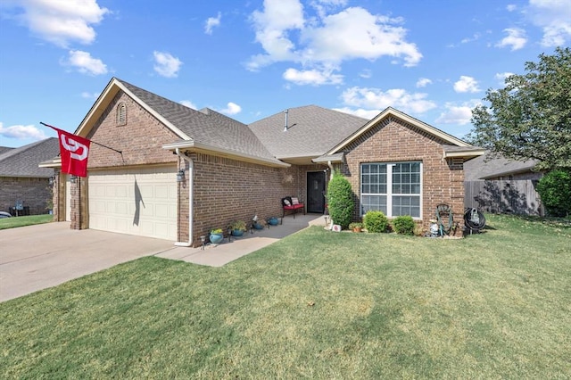 ranch-style house featuring a garage and a front lawn