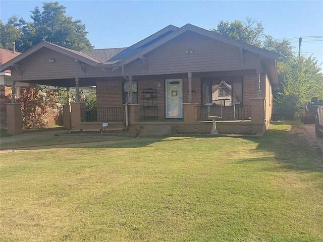 view of front facade featuring covered porch and a front lawn