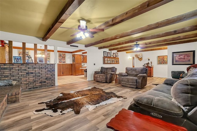 living room featuring beamed ceiling and light wood-type flooring