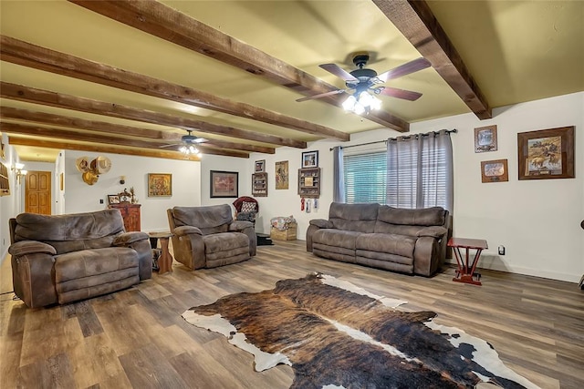 living room featuring beamed ceiling, hardwood / wood-style floors, and ceiling fan