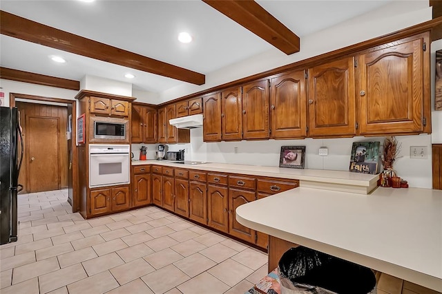 kitchen featuring black appliances and beam ceiling