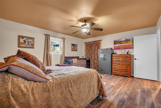 bedroom featuring hardwood / wood-style floors and ceiling fan