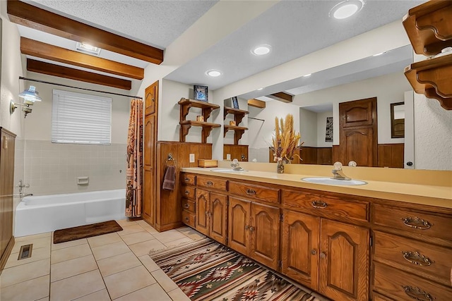 bathroom featuring vanity, tile patterned floors, shower / bathtub combination with curtain, a textured ceiling, and beamed ceiling