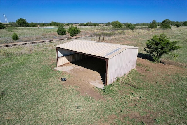 view of outdoor structure with a rural view