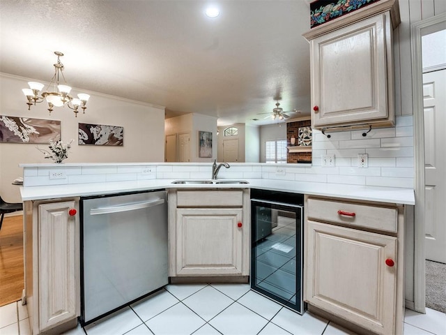 kitchen featuring beverage cooler, stainless steel dishwasher, kitchen peninsula, plenty of natural light, and ceiling fan with notable chandelier