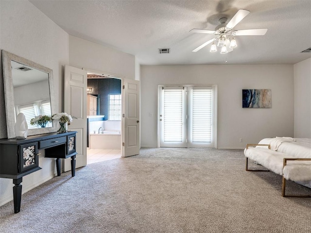 living area with ceiling fan, light colored carpet, and a textured ceiling