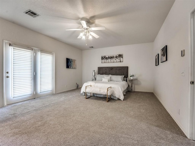 bedroom featuring ceiling fan, carpet floors, and a textured ceiling