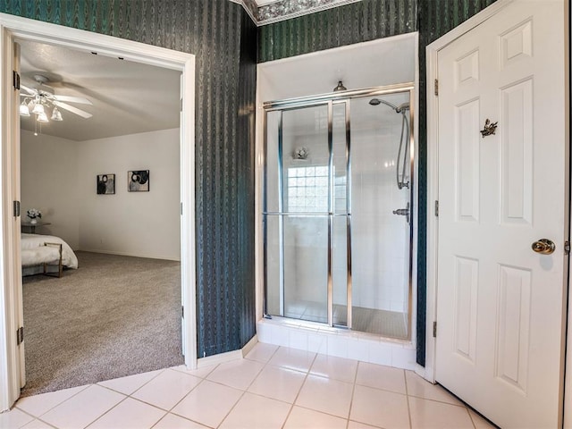 bathroom with tile patterned floors, ceiling fan, and a shower with shower door