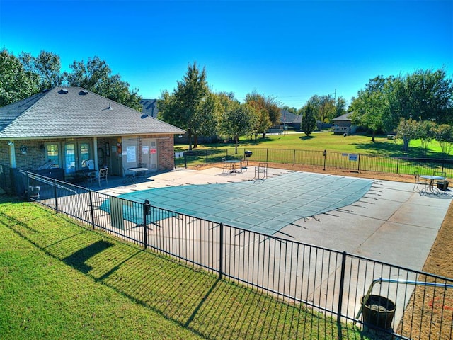 pool featuring fence, a lawn, and a patio