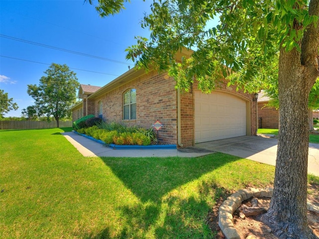 view of property exterior with an attached garage, a yard, brick siding, and concrete driveway