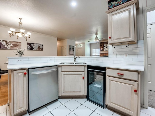 kitchen featuring beverage cooler, a sink, light countertops, dishwasher, and tasteful backsplash