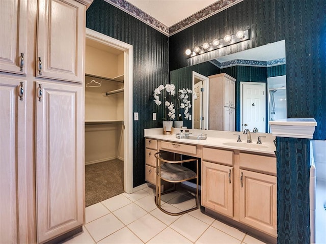 full bath with wallpapered walls, baseboards, tile patterned floors, a walk in closet, and vanity