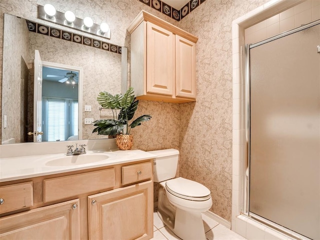 bathroom featuring toilet, wallpapered walls, and a shower stall