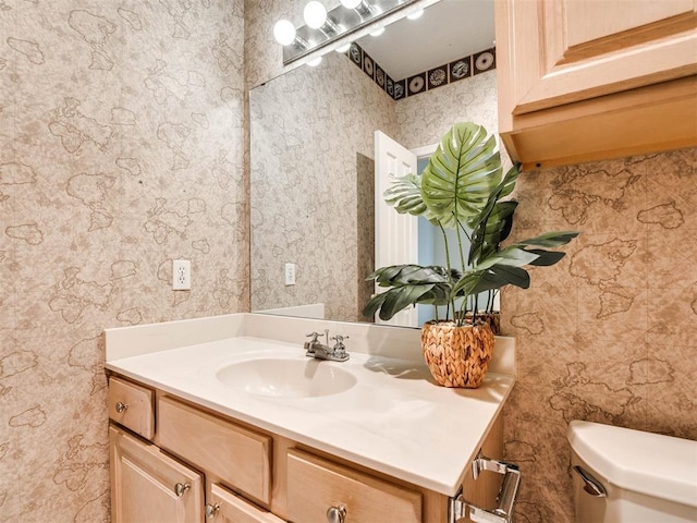 half bathroom with toilet and vanity