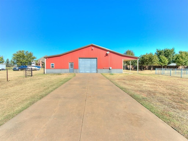 exterior space featuring a garage, an outbuilding, and a yard