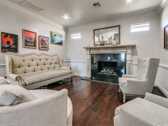 living room with plenty of natural light, wood-type flooring, and ornamental molding