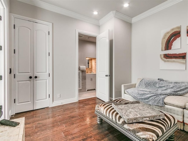 living area with dark hardwood / wood-style flooring and crown molding