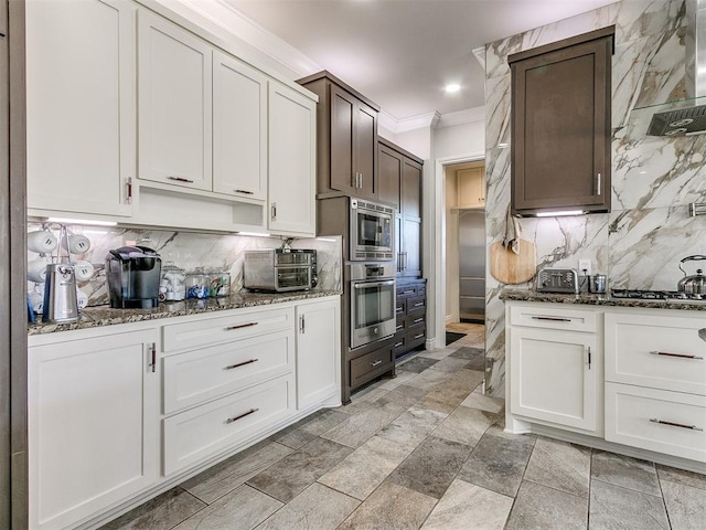 kitchen featuring white cabinets, backsplash, and appliances with stainless steel finishes