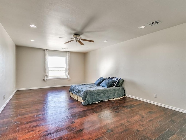 bedroom with ceiling fan and dark hardwood / wood-style floors