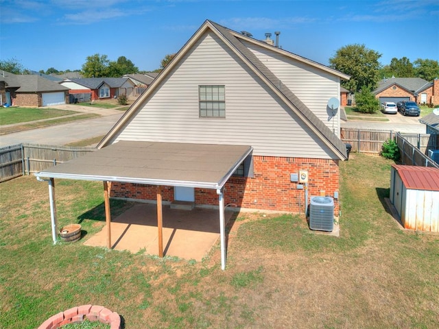 back of property featuring central AC, a yard, and a patio