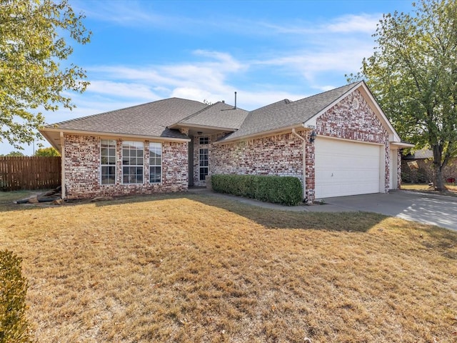 ranch-style house featuring a front lawn and a garage