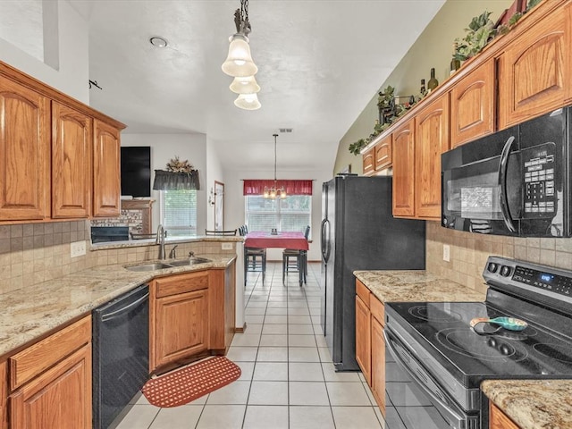 kitchen featuring tasteful backsplash, sink, black appliances, decorative light fixtures, and an inviting chandelier