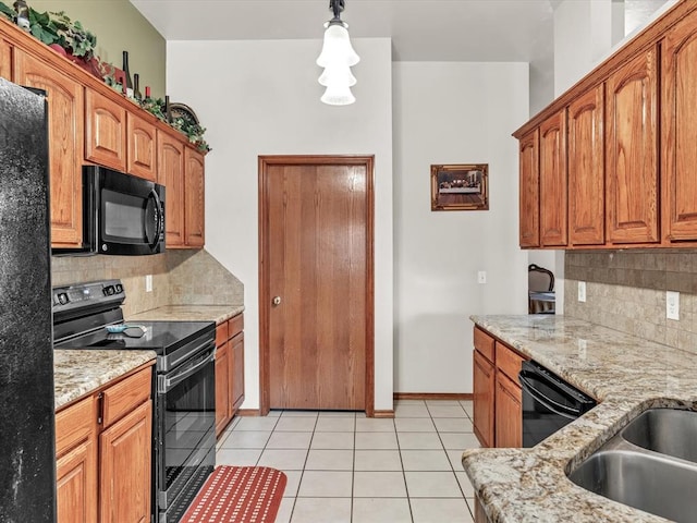 kitchen with decorative backsplash, decorative light fixtures, light tile patterned flooring, and black appliances