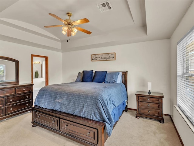 bedroom featuring ceiling fan, lofted ceiling, light carpet, and connected bathroom