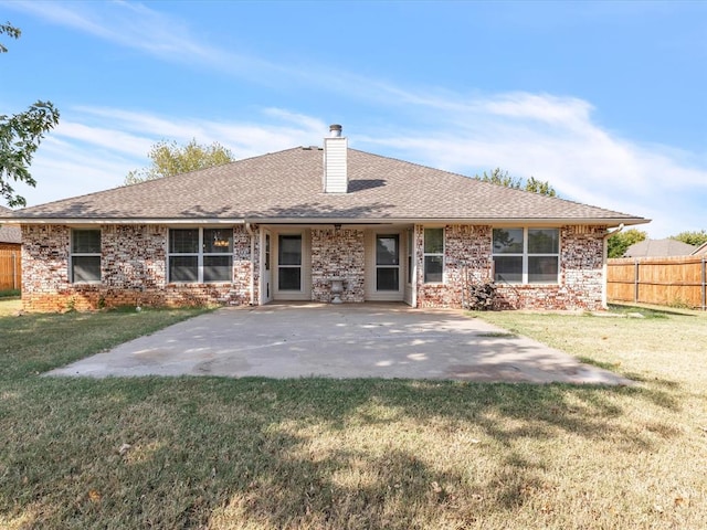 rear view of property featuring a patio area and a yard